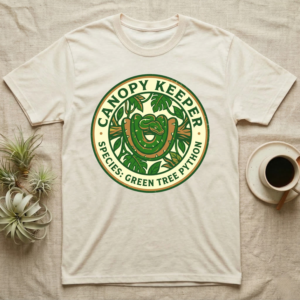 Canopy Keeper Green Tree Python logo on a light beige t-shirt.
