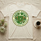 Canopy Keeper Green Tree Python logo on a light beige t-shirt.