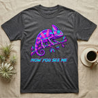Dark t-shirt with neon purple and blue chameleon on branch, "NOW YOU SEE ME" text.