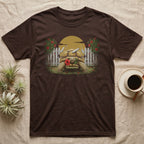 Sulcata Hibiscus Thief T-Shirt in Dark Chocolate — Painted 90s wildlife art of a sulcata tortoise walking through a broken picket fence with a red hibiscus flower in its beak