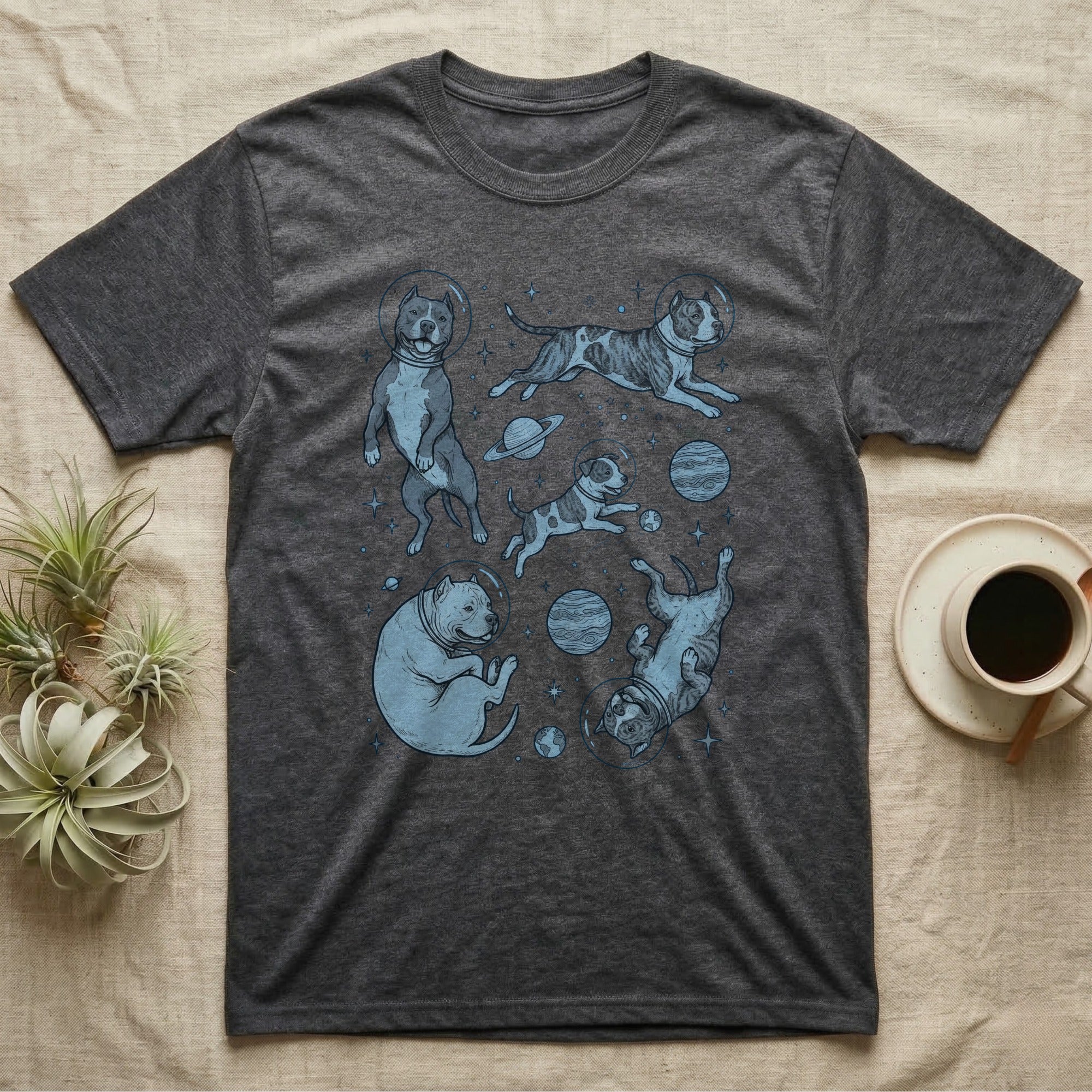 T-shirt with a pattern of pit bulls in space suits floating among planets.
