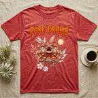 Frilled Dragon Feral T-Shirt in Heather Red — Frilled dragon with its neck frill flared and mouth gaping under a jagged fiery-orange metal "PURE DRAMA" wordmark.