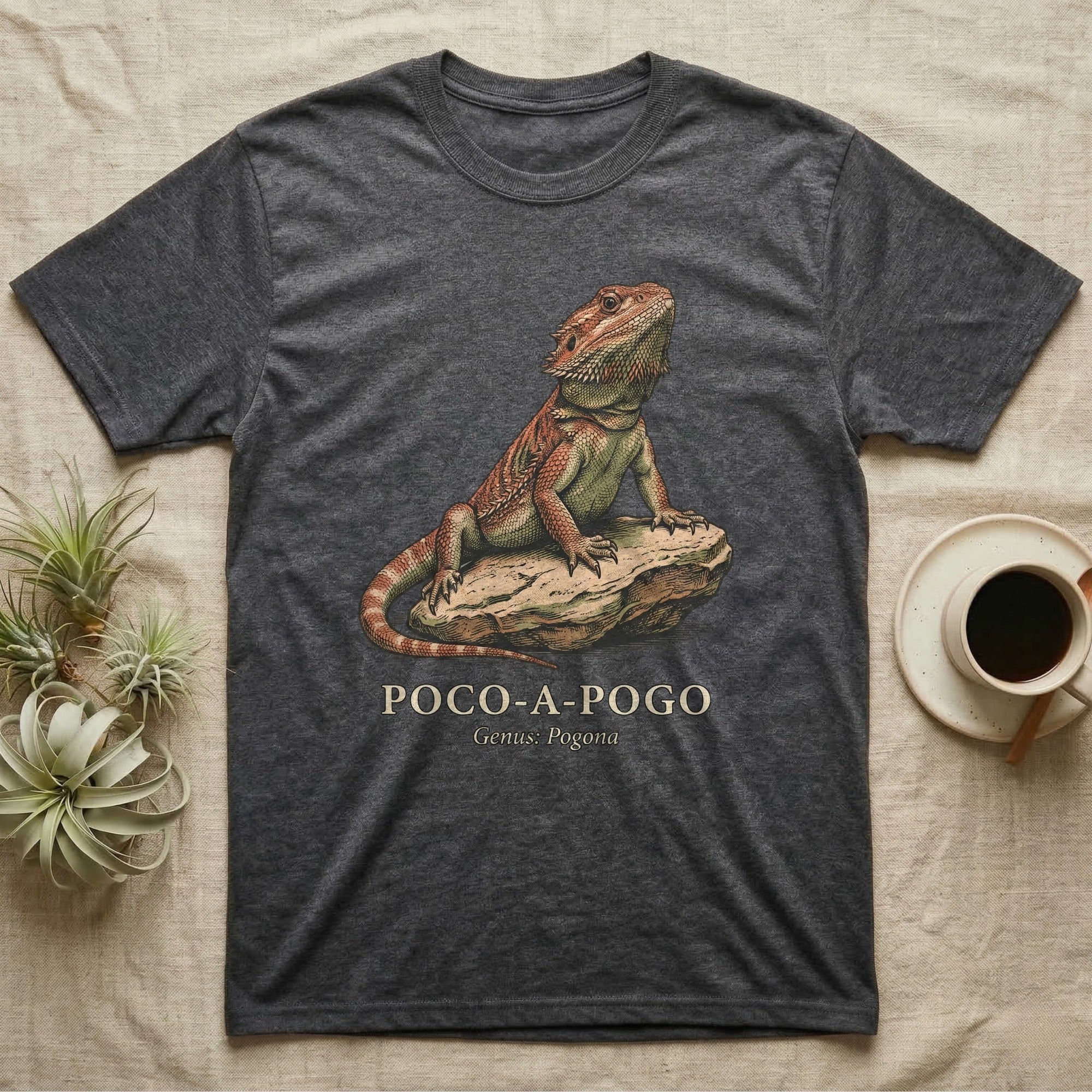 Dark grey t-shirt with a bearded dragon on a rock and text.