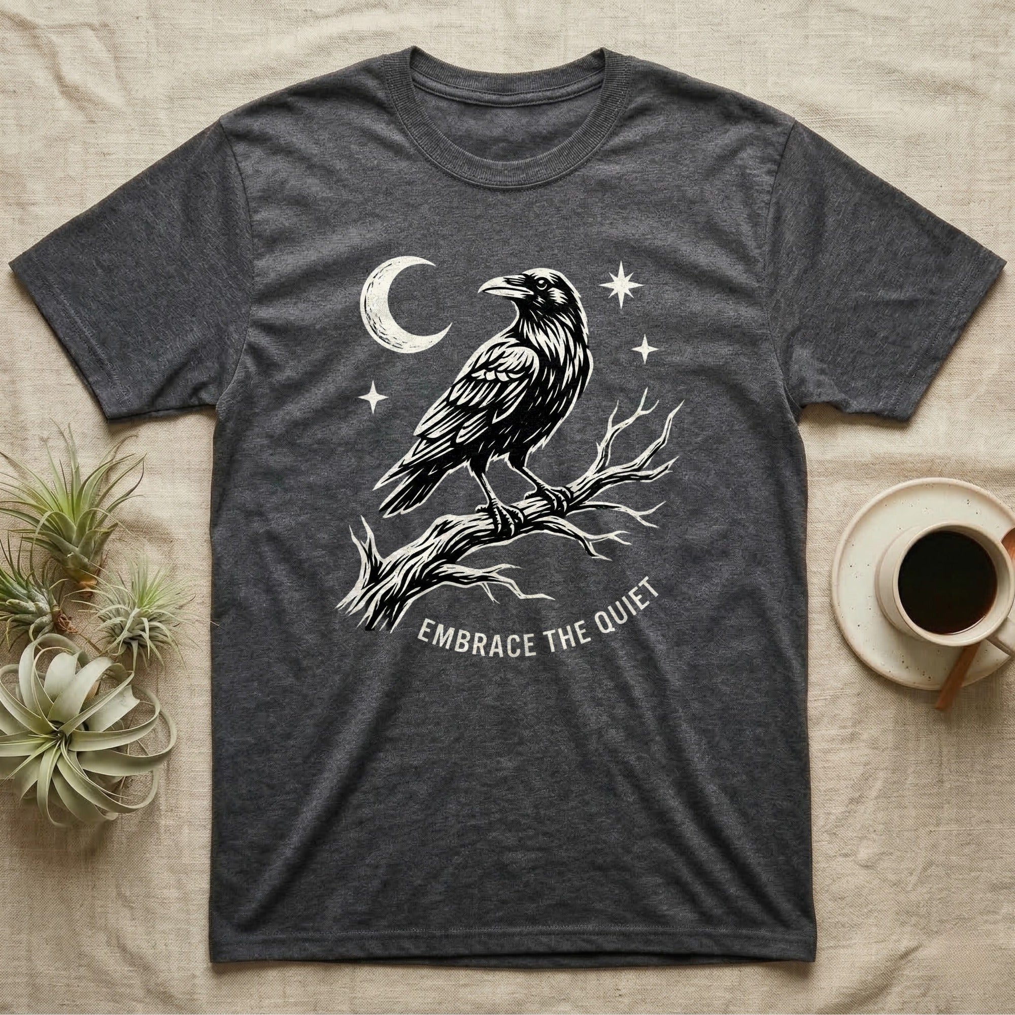 Charcoal t-shirt with raven on a branch, moon, and stars; text "EMBRACE THE QUIET".