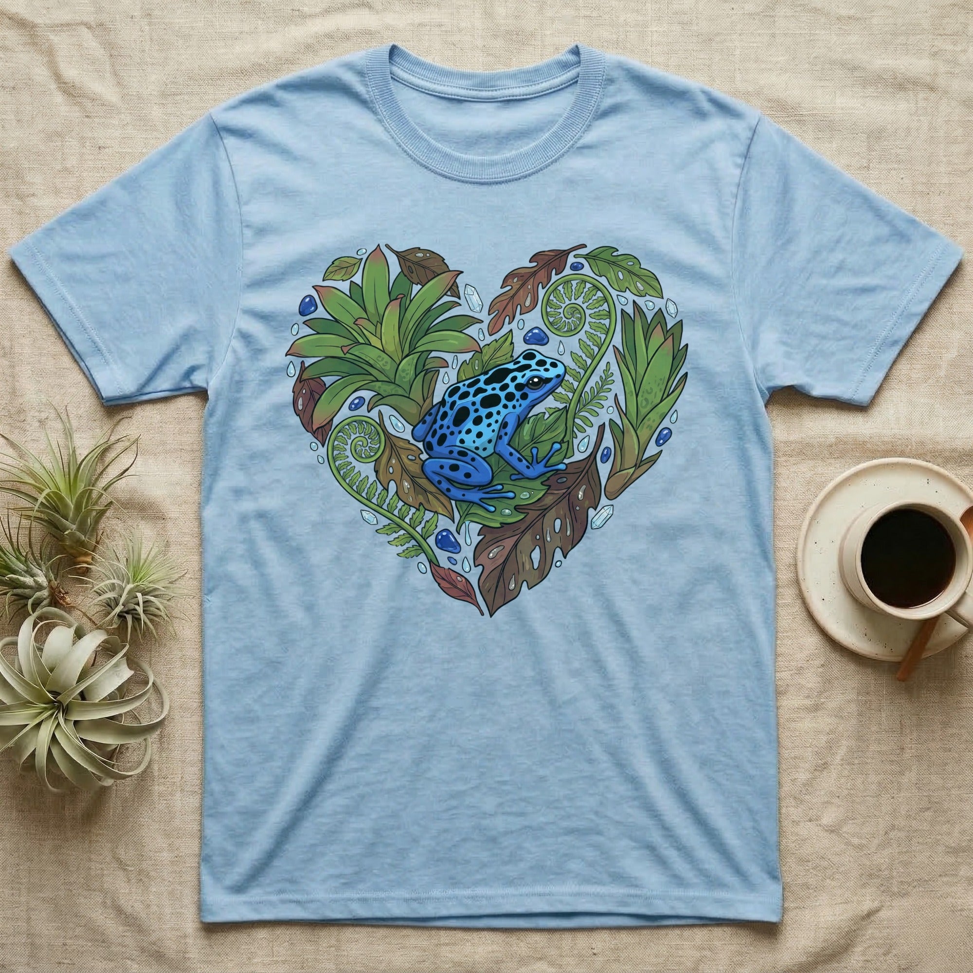 Blue t-shirt with a blue poison dart frog in a heart-shaped botanical design.