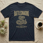 Corn Snake Rattlesnaking T-Shirt in Navy — Distressed woodblock corn snake coiled with tail flicked out under an arched "Rattlesnaking" headline.
