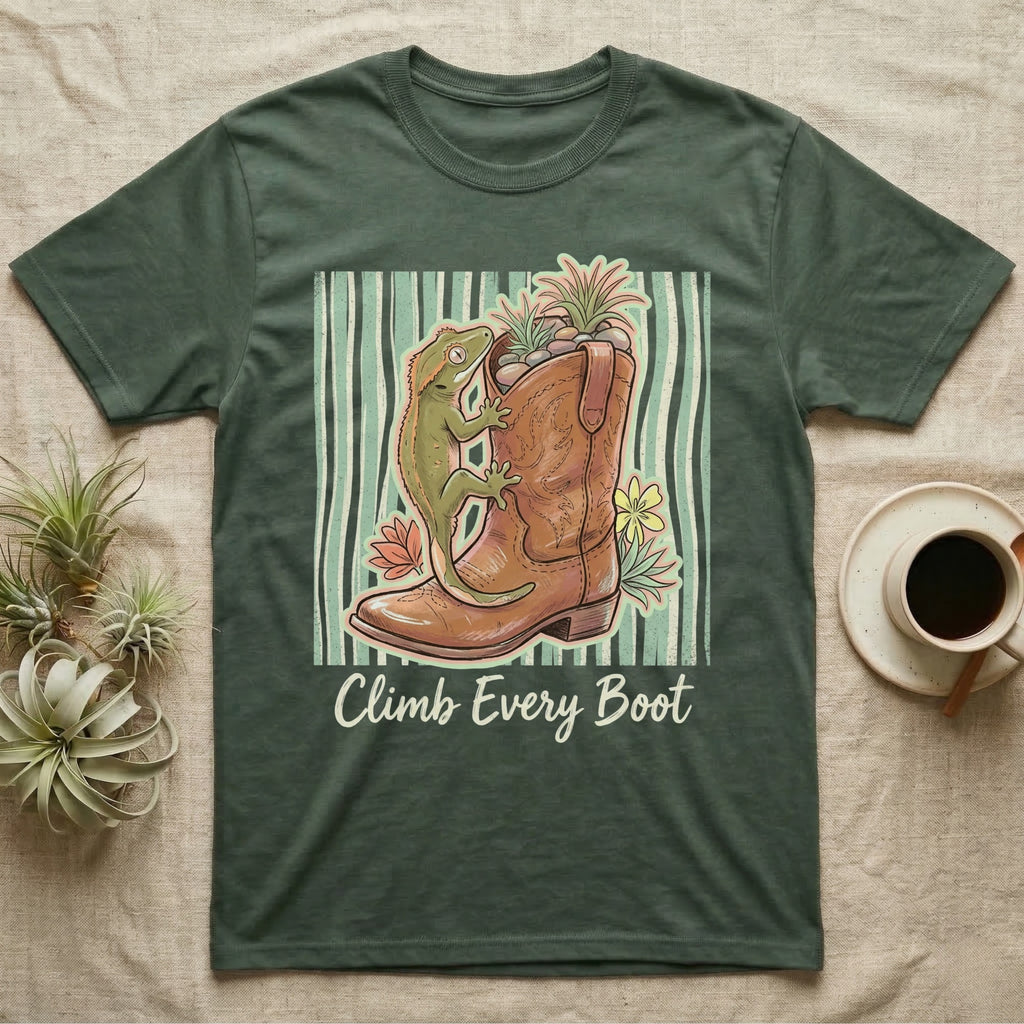 Green t-shirt with a gecko climbing a cowboy boot, surrounded by plants.