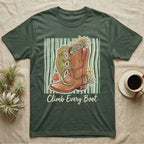 Green t-shirt with a gecko climbing a cowboy boot, surrounded by plants.