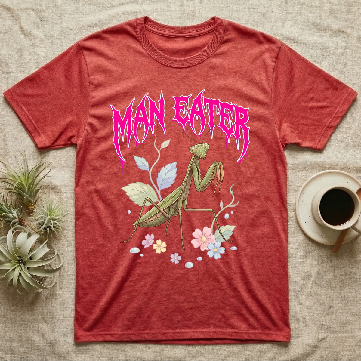 Chinese Mantis Feral T-Shirt in Heather Red — Pastel Chinese mantis with raised spiked forelegs among leaves and blossoms, jagged magenta metal wordmark "MAN EATER" above.