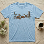 Box Turtle Forest Floor T-Shirt in Light Blue — Sepia ink and wash illustration of eight eastern box turtles crossing open woodland between two deadfall trunks.
