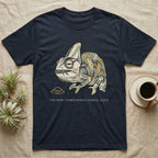 Unbothered Chameleon T-Shirt in Navy — Ukiyo-e woodblock illustration of a veiled chameleon mid-chew with a deadpan serif caption beneath the subject.