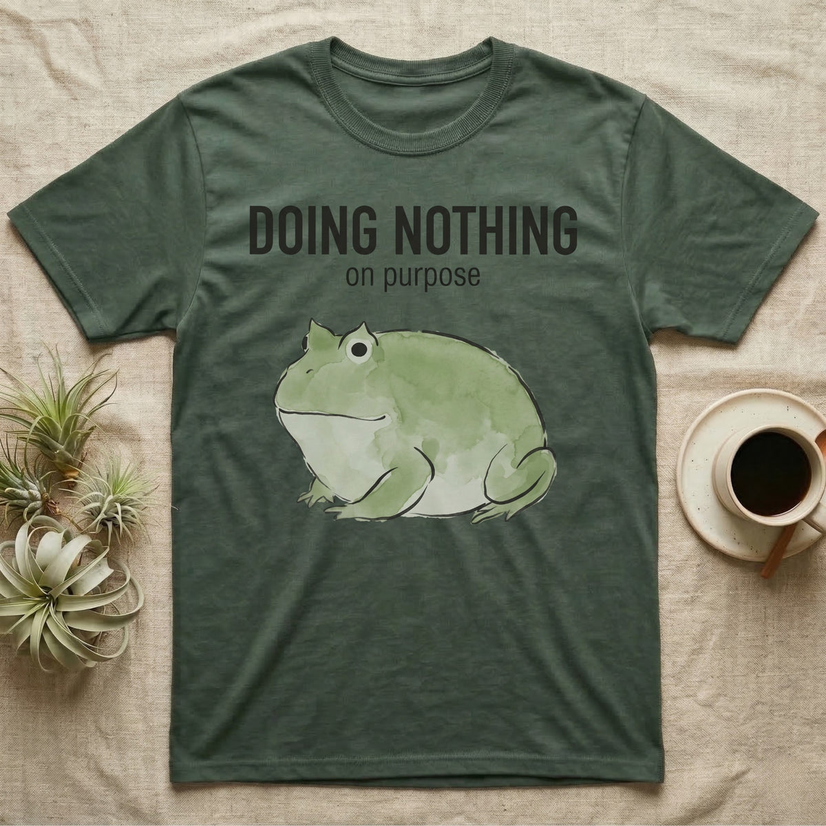 Pacman Frog Doing Nothing T-Shirt in Military Green — Watercolour pacman frog blob in profile below the words doing nothing on purpose, on grey