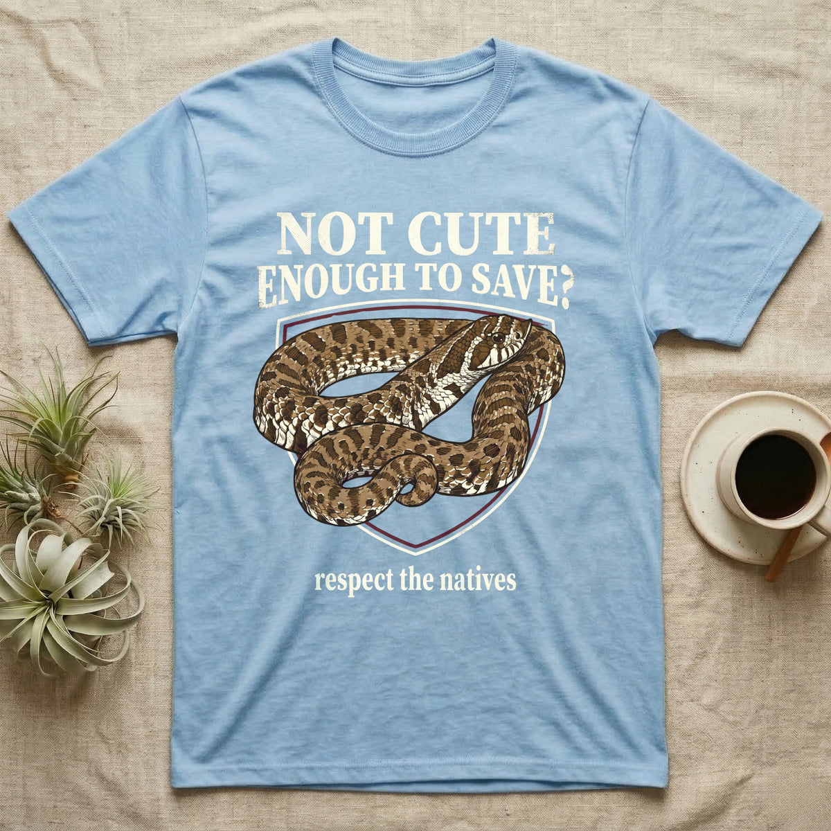 Hognose Snake Conservation T-Shirt in Light Blue — Vintage-poster illustration of a western hognose snake portrait in a sepia crest with conservation banner text.