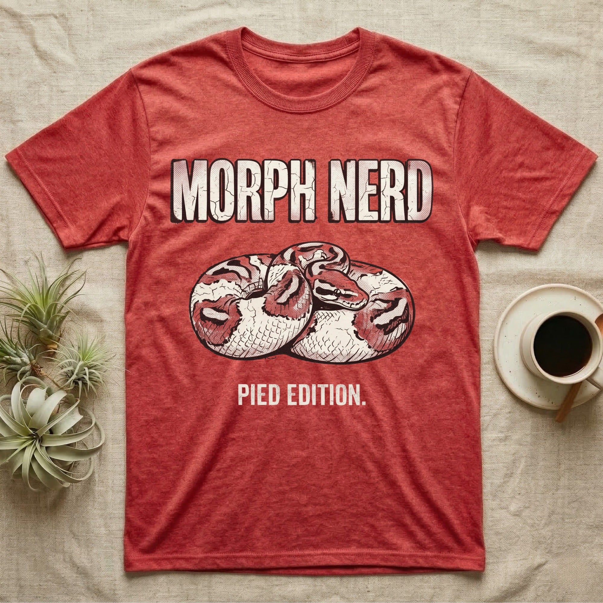Pied Ball Python Morph T-Shirt in Heather Red — Grunge type "Morph Nerd" with a small pied-morph ball python coiled mid-design and "Pied Edition" caption beneath.