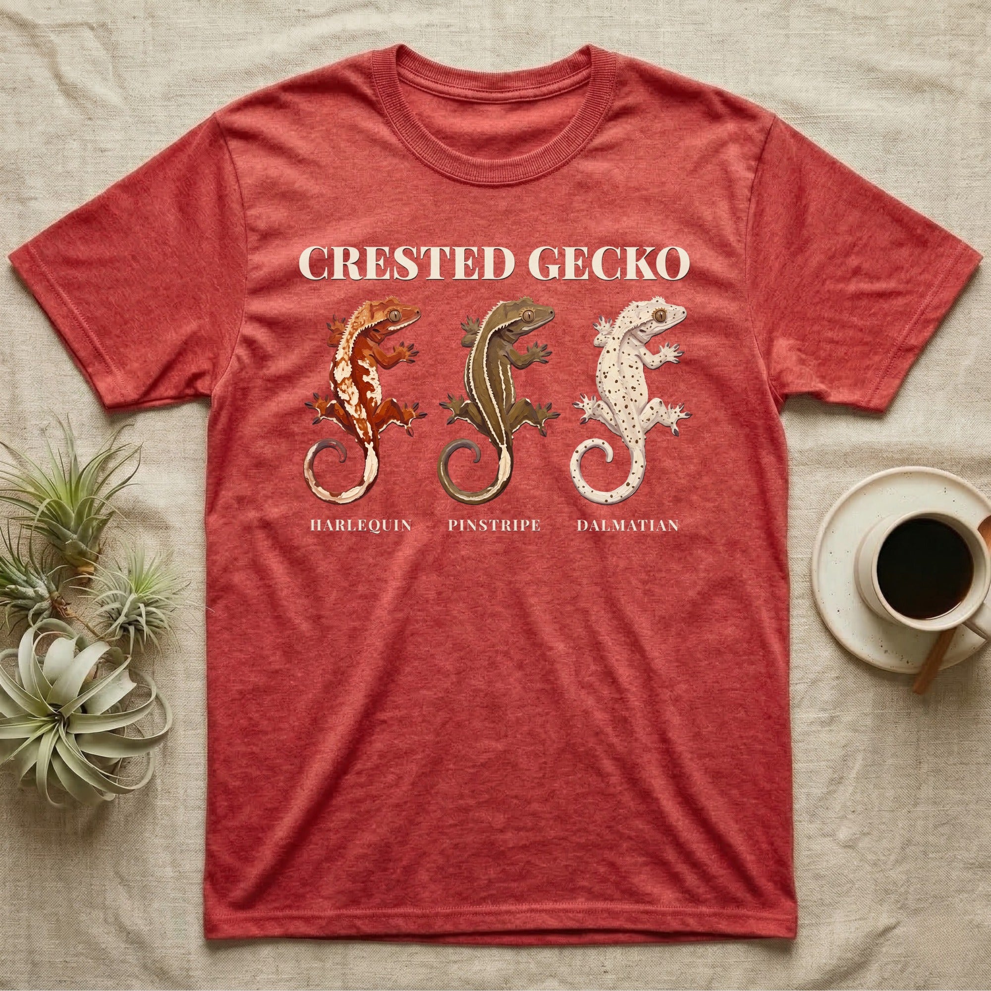 Crested Gecko Morph Chart T-Shirt in Heather Red — Impasto painted chart of three crested gecko morphs — harlequin, pinstripe and dalmatian — labelled beneath each gecko.