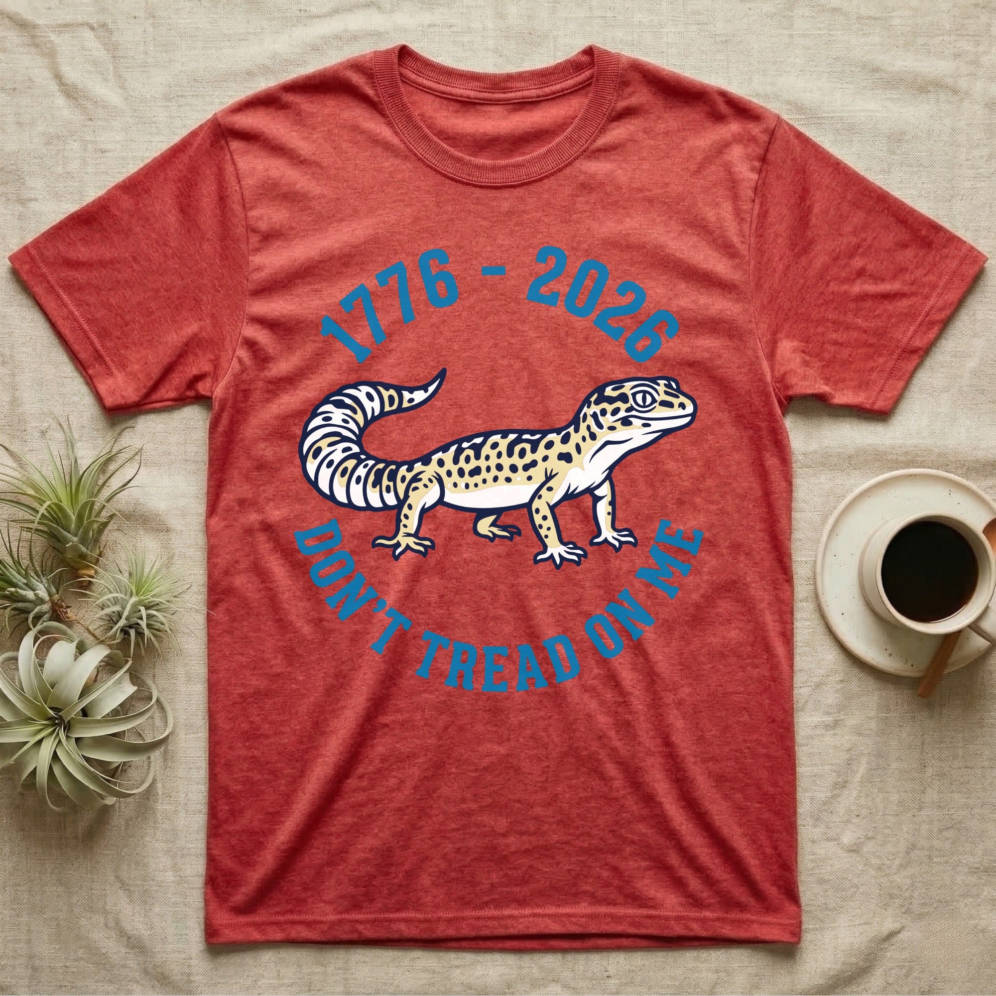 Leopard Gecko 1776 T-Shirt in Heather Red — Two-colour vector leopard gecko in profile ringed by arched text reading 1776 to 2026 and Don't Tread On Me.