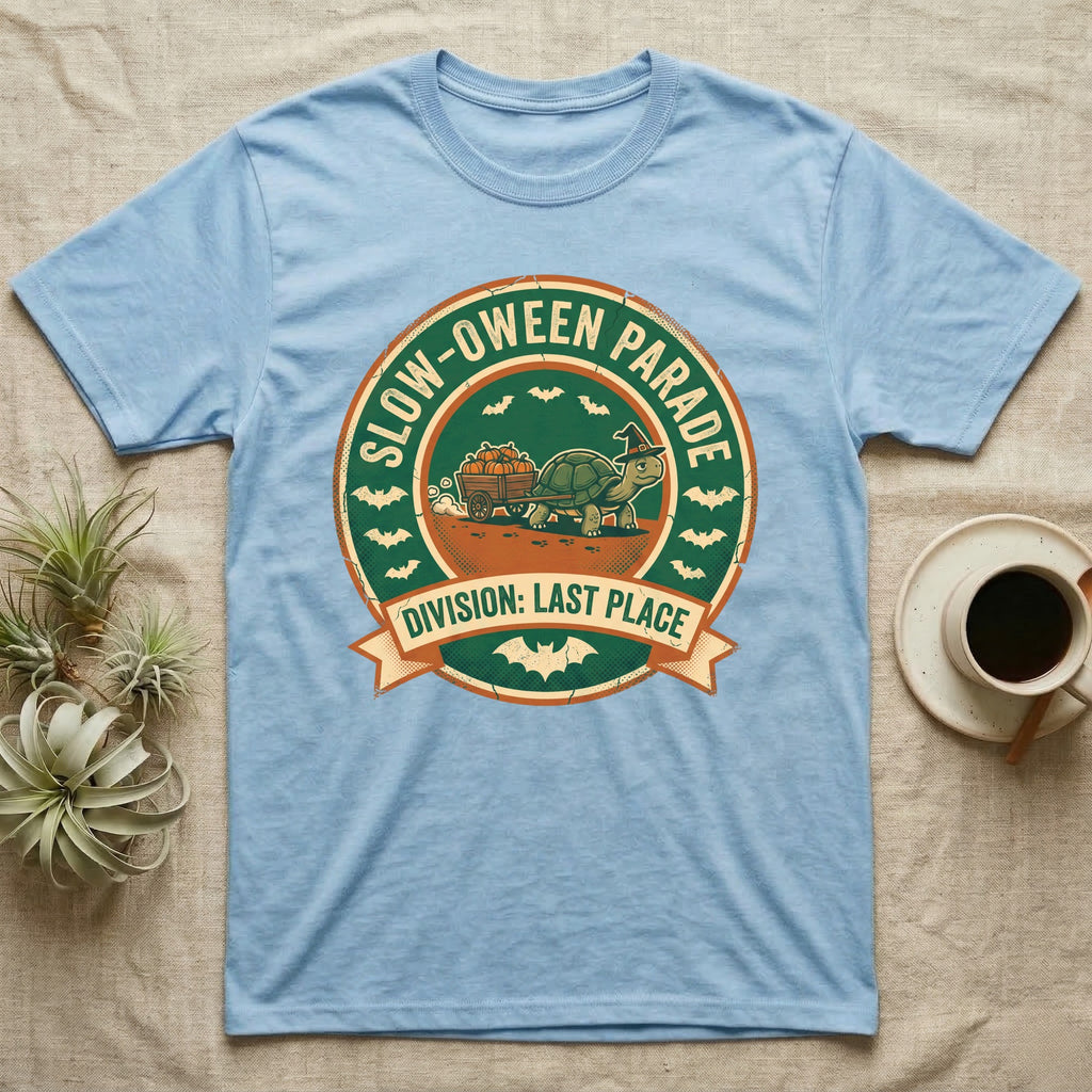 Tortoise Slow-oween Parade T-Shirt in Light Blue — Distressed badge of a witch-hatted tortoise pulling a pumpkin wagon, "Slow-oween Parade, Division Last Place."