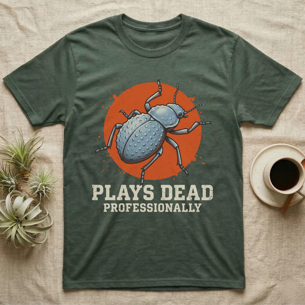 Blue Death Feigning Beetle T-Shirt in Military Green — Distressed disc portrait of a blue death-feigning beetle over an orange circle with text plays dead