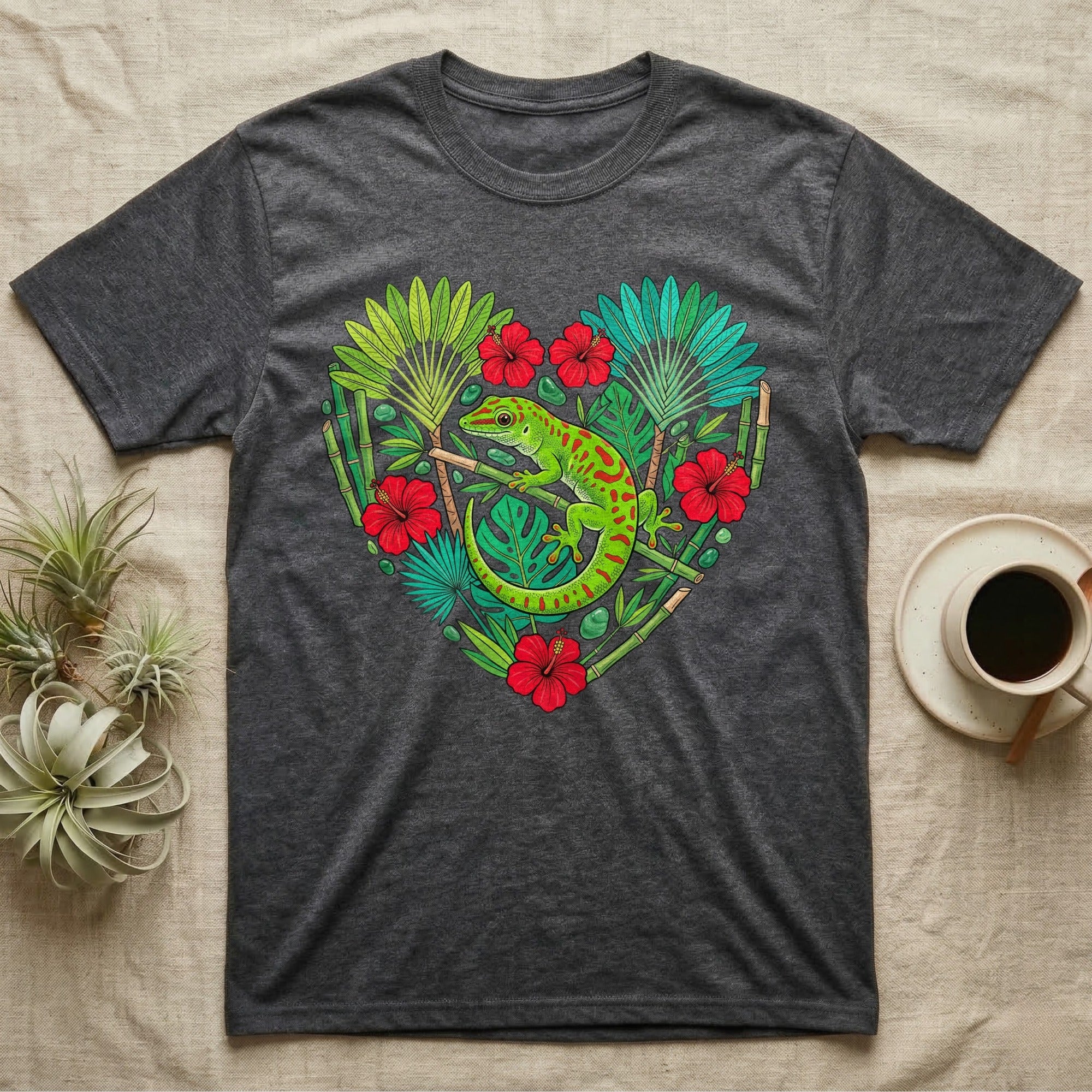 Dark gray t-shirt with a heart-shaped design of a gecko, bamboo, and tropical flowers.