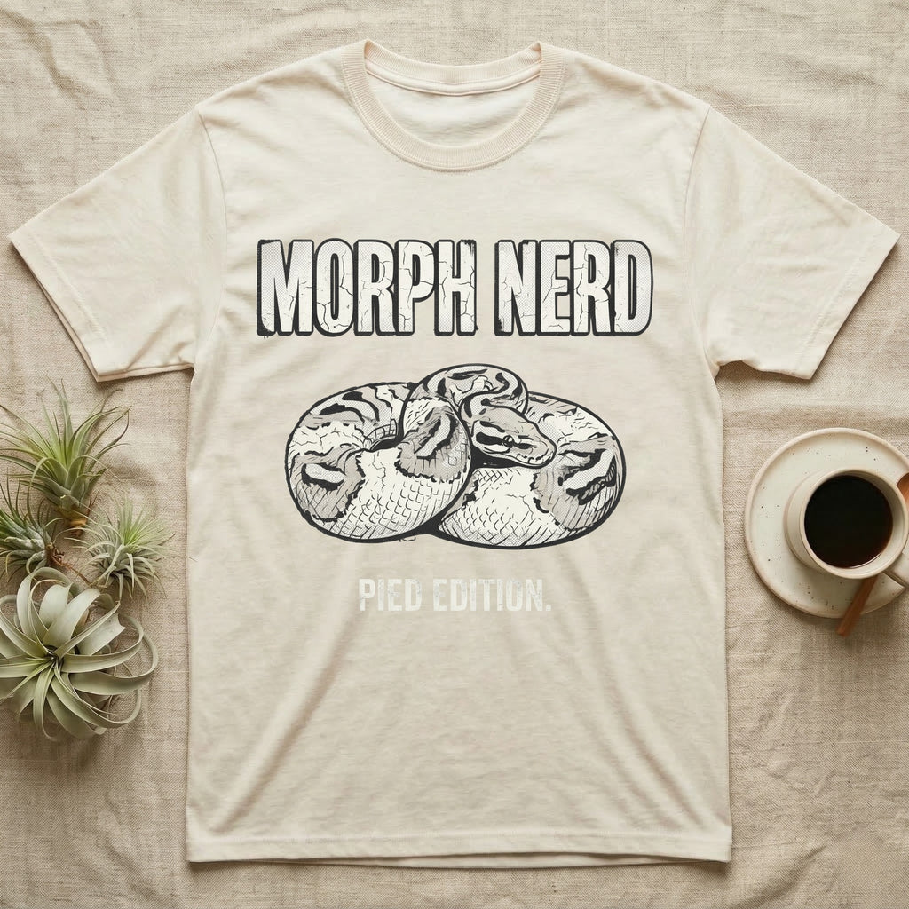 Pied Ball Python Morph T-Shirt in Natural — Grunge type "Morph Nerd" with a small pied-morph ball python coiled mid-design and "Pied Edition" caption beneath.