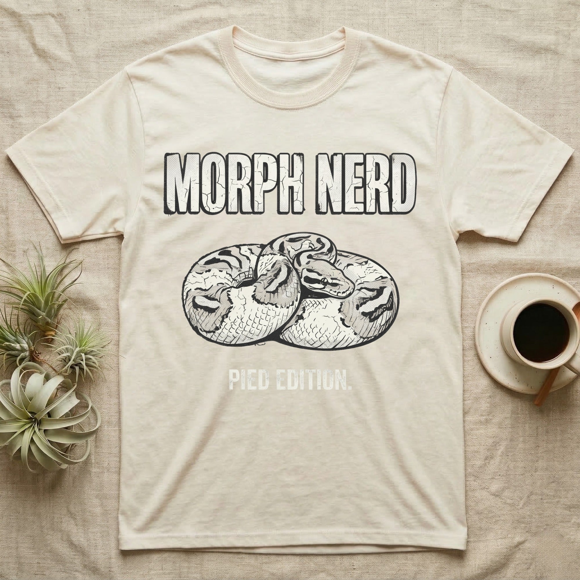 Pied Ball Python Morph T-Shirt in Natural — Grunge type "Morph Nerd" with a small pied-morph ball python coiled mid-design and "Pied Edition" caption beneath.