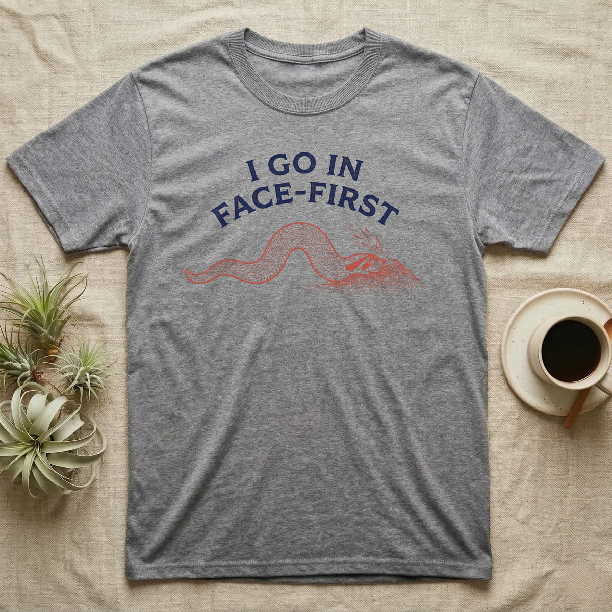 Western Hognose Face-First T-Shirt in Sport Grey — Two-ink worn-stamp print of a western hognose snake digging head-first into a mound of sand beneath arched text reading I GO IN FACE-FIRST.