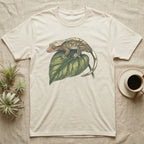 Cream t-shirt with a gecko on a green leaf graphic.