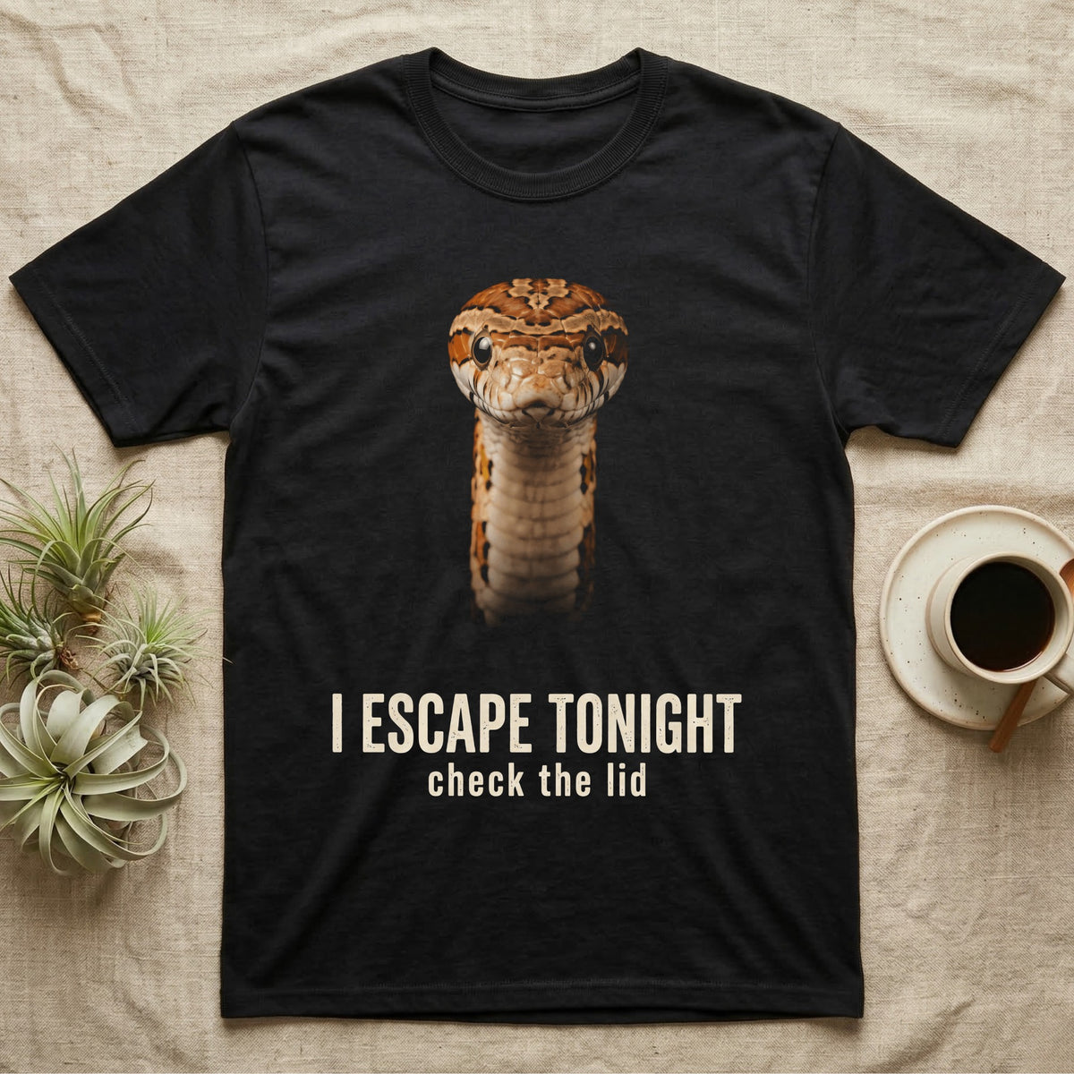 Photographic mugshot of a corn snake coiled and staring into the lens above the hook I Escape Tonight, check the lid. — shown on a Black tee.