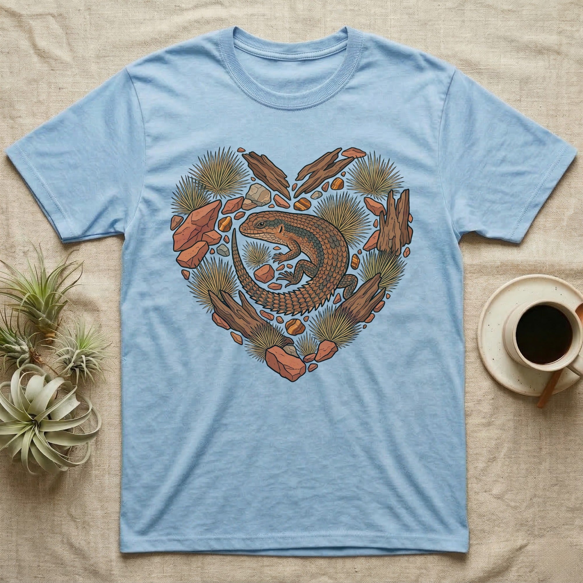Light blue t-shirt with a heart-shaped desert scene featuring a lizard.