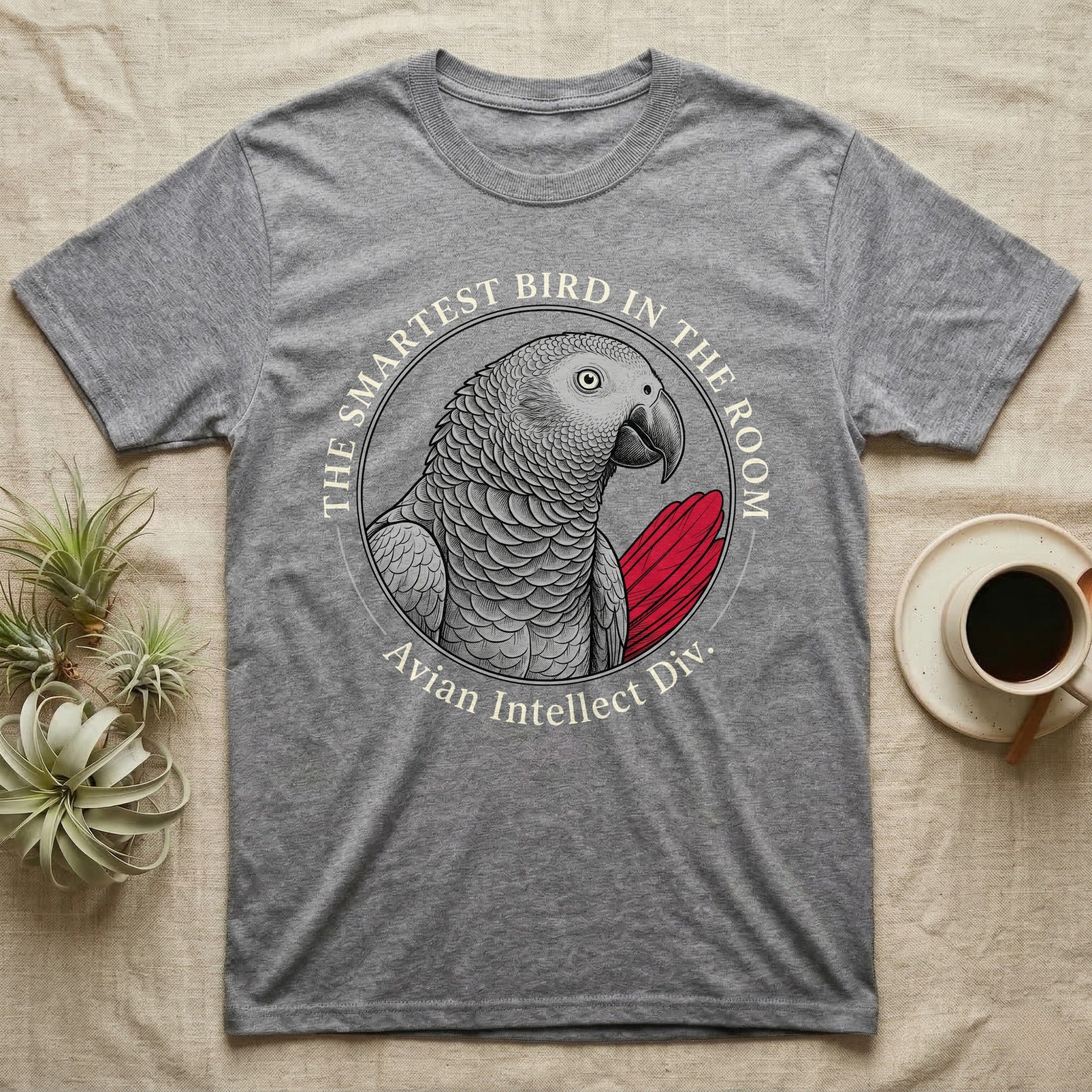 Grey t-shirt with an illustration of a parrot and text "The Smartest Bird In The Room".
