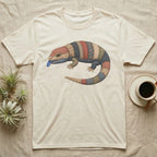 Cream t-shirt with a quilt-patterned lizard graphic and blue tongue.