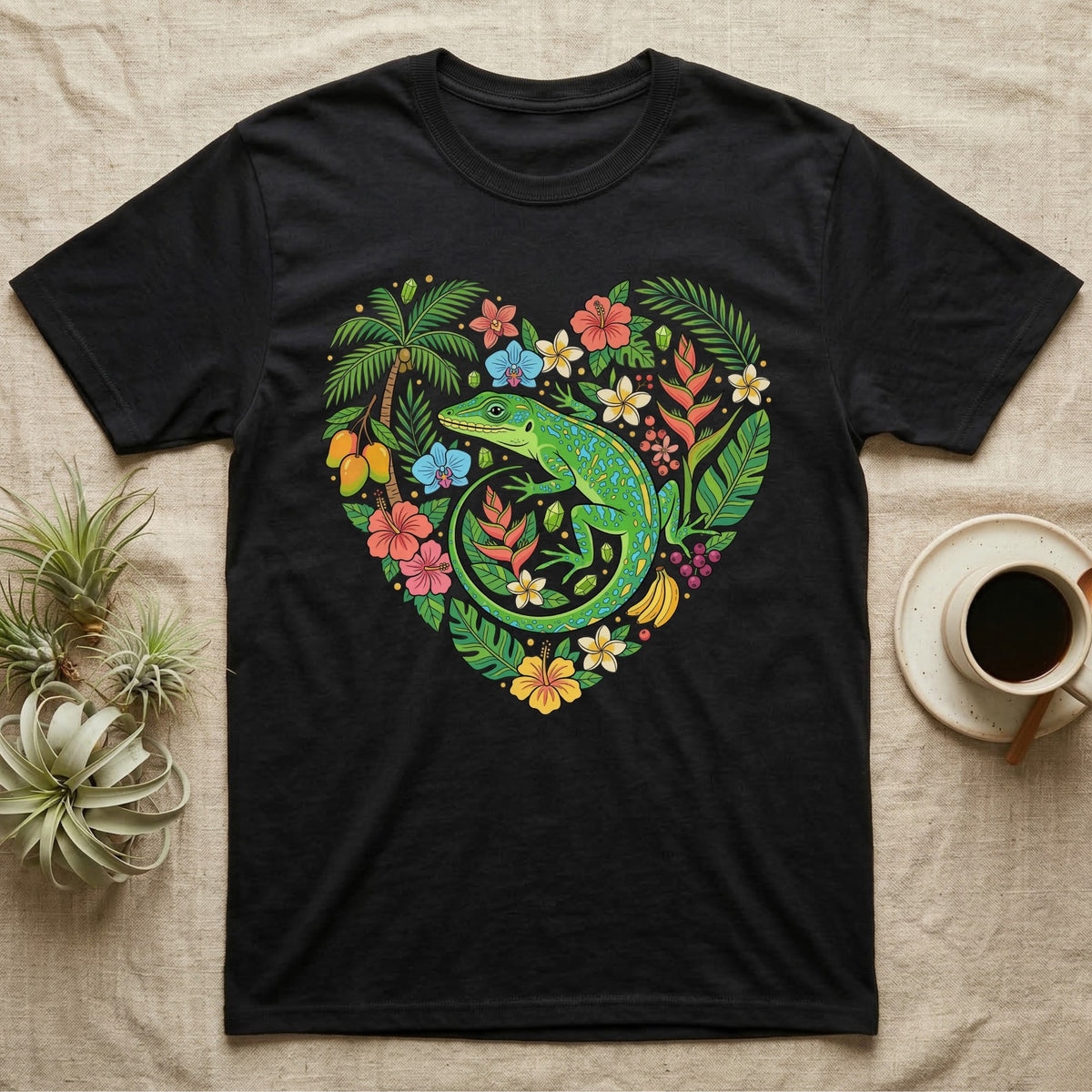 Black t-shirt with a vibrant heart-shaped design of a lizard, flowers, and tropical foliage.