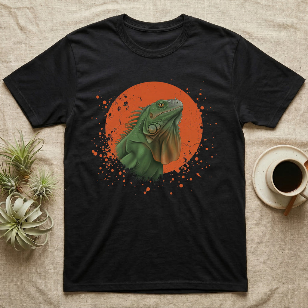 Green Iguana Stink Face T-Shirt in Black — Distressed vintage-style illustration of a green iguana with its dewlap fully dropped and chin lifted, on an orange disc.