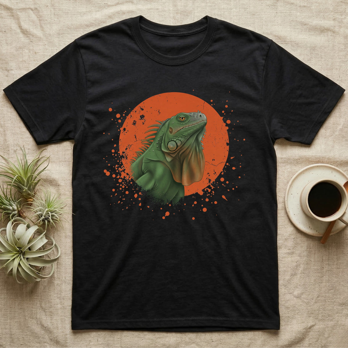 Green Iguana Stink Face T-Shirt in Black — Distressed vintage-style illustration of a green iguana with its dewlap fully dropped and chin lifted, on an orange disc.