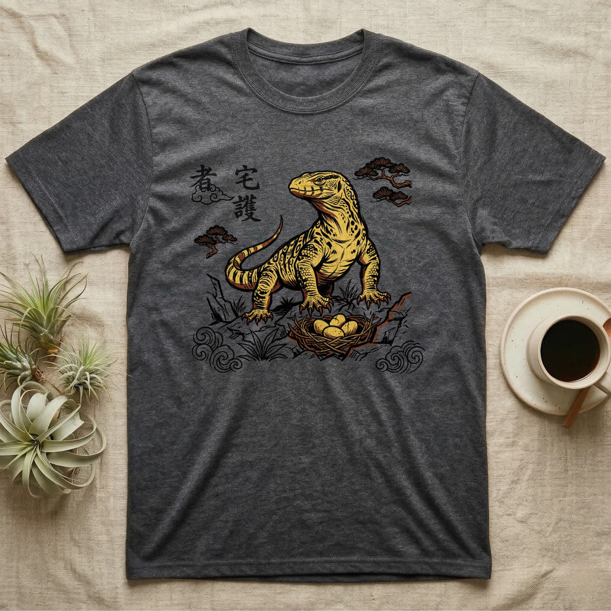 Dark grey t-shirt with Komodo dragon and eggs graphic, featuring East Asian-style clouds and text.