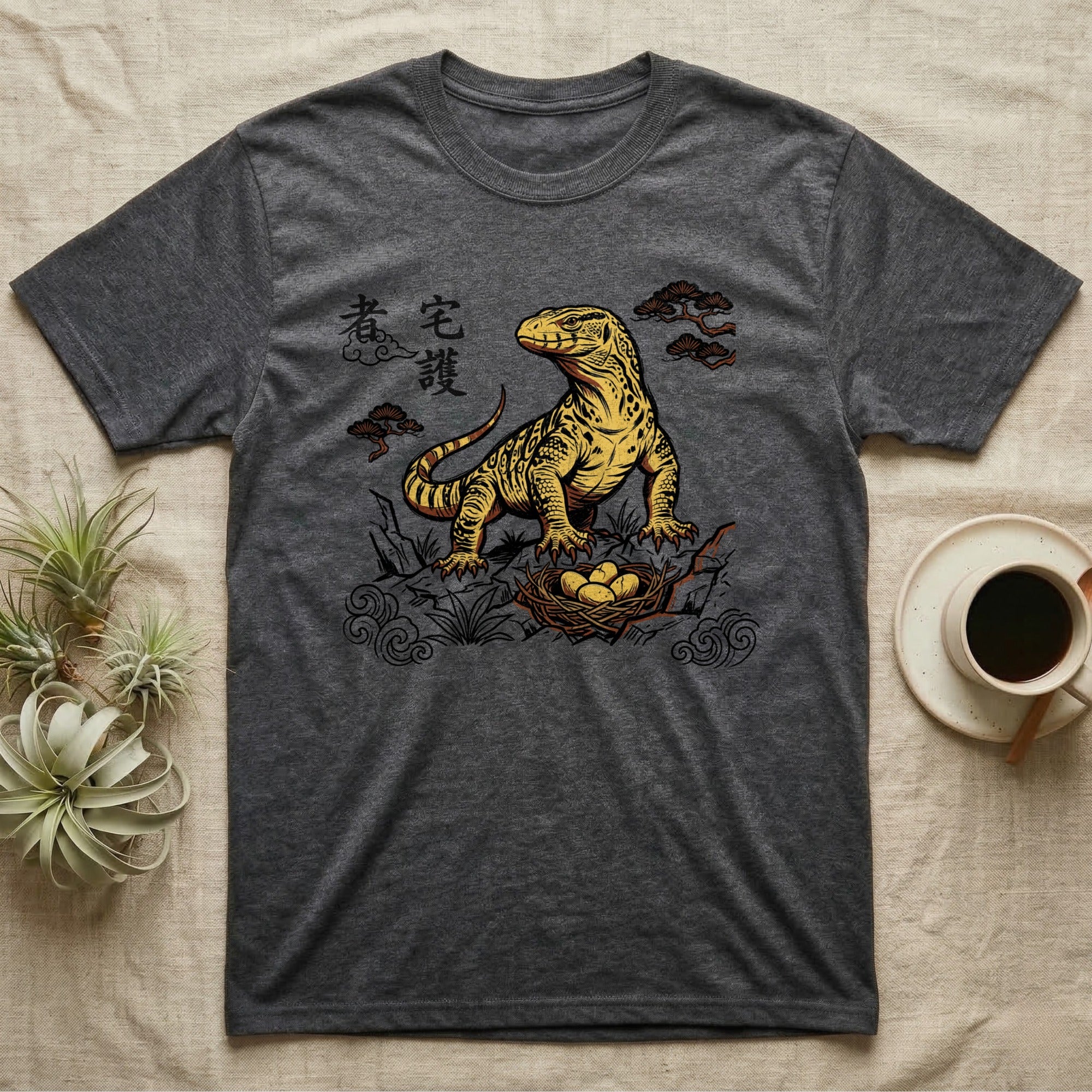 Dark grey t-shirt with Komodo dragon and eggs graphic, featuring East Asian-style clouds and text.