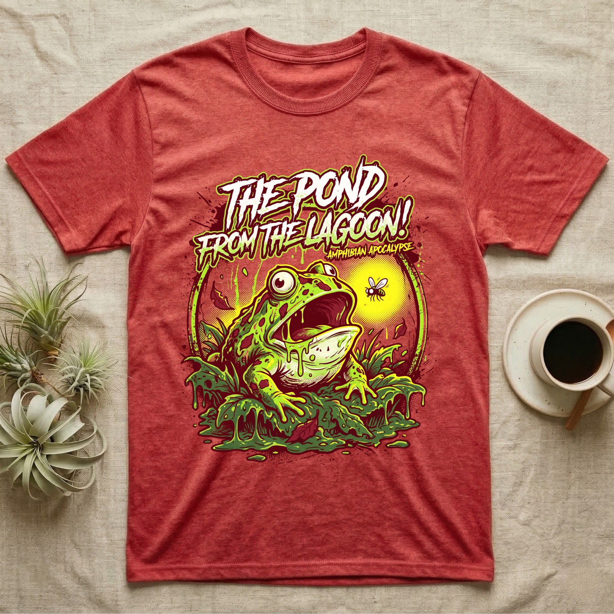 Pacman Frog Lagoon Apocalypse T-Shirt in Heather Red — B-movie horror poster of a Pacman frog bursting from slime at a fly, "The Pond From the Lagoon, Amphibian Apocalypse."