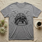 Sulcata Tortoise Charcoal Grit T-Shirt in Sport Grey — Sulcata tortoise drawn head-on in scribbled charcoal grit, legs braced wide, zigzag bolts thrown out around it.