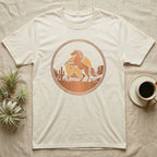 Cream t-shirt with desert sunset graphic featuring a rearing horse.