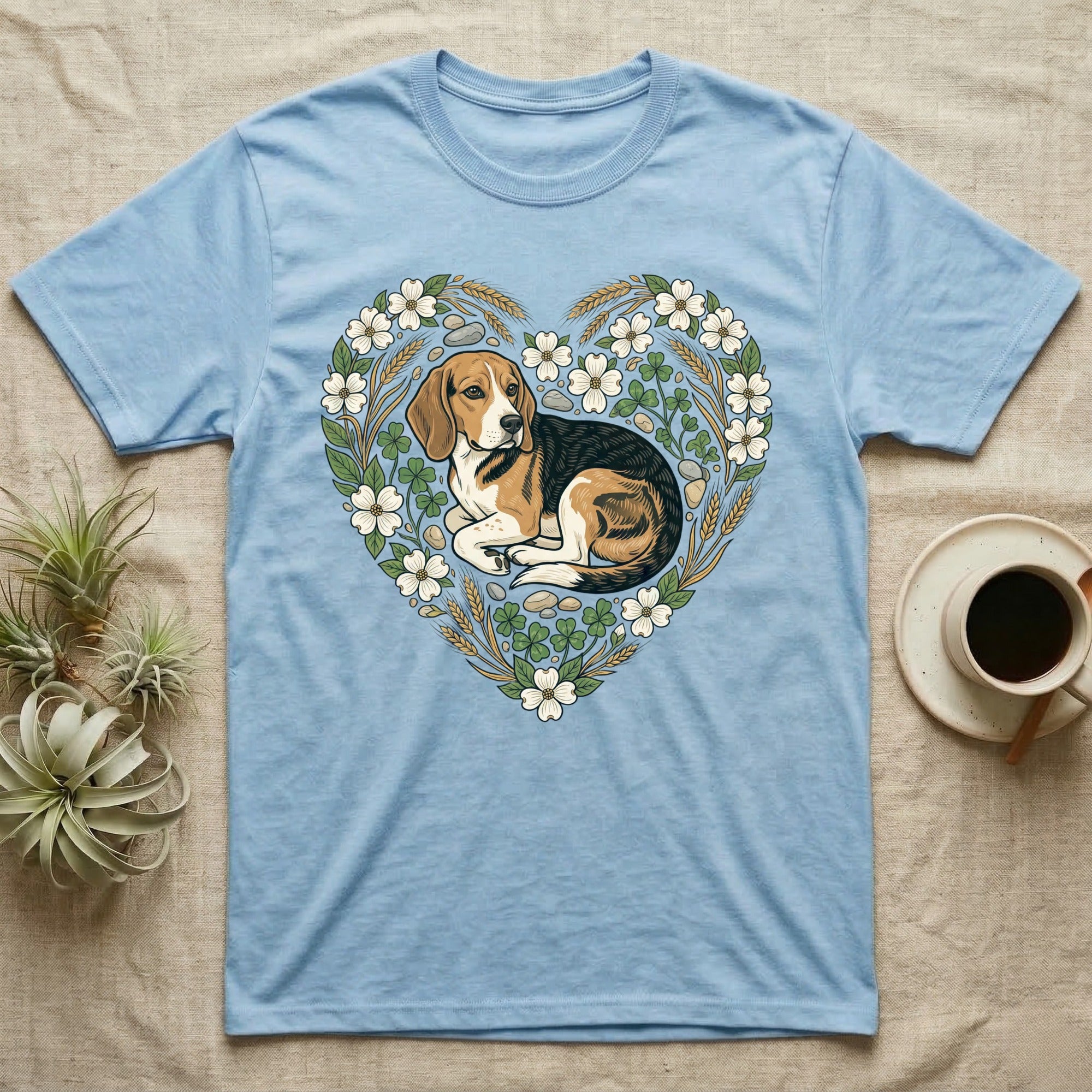 Beagle dog inside a floral heart on a light blue t-shirt.