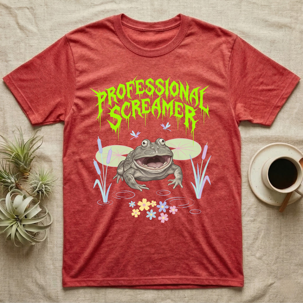 Budgett's Frog Feral T-Shirt in Heather Red — Budgett's frog with wide screaming mouth under jagged acid-green metal text PROFESSIONAL SCREAMER with lily pads