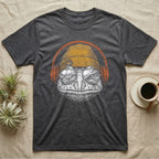 Pacman Frog Chill Beats T-Shirt in Dark Heather — Engraved Pacman horned frog with wide bumpy skin in a beanie and headphones, aviators reflecting a woodland pond.
