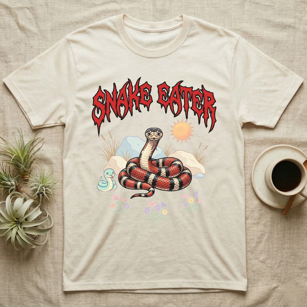 California Kingsnake Feral T-Shirt in Natural — Banded California kingsnake coiled with a tiny companion snake under a jagged blood-red metal wordmark and pastel scene.