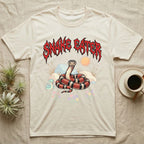 California Kingsnake Feral T-Shirt in Natural — Banded California kingsnake coiled with a tiny companion snake under a jagged blood-red metal wordmark and pastel scene.