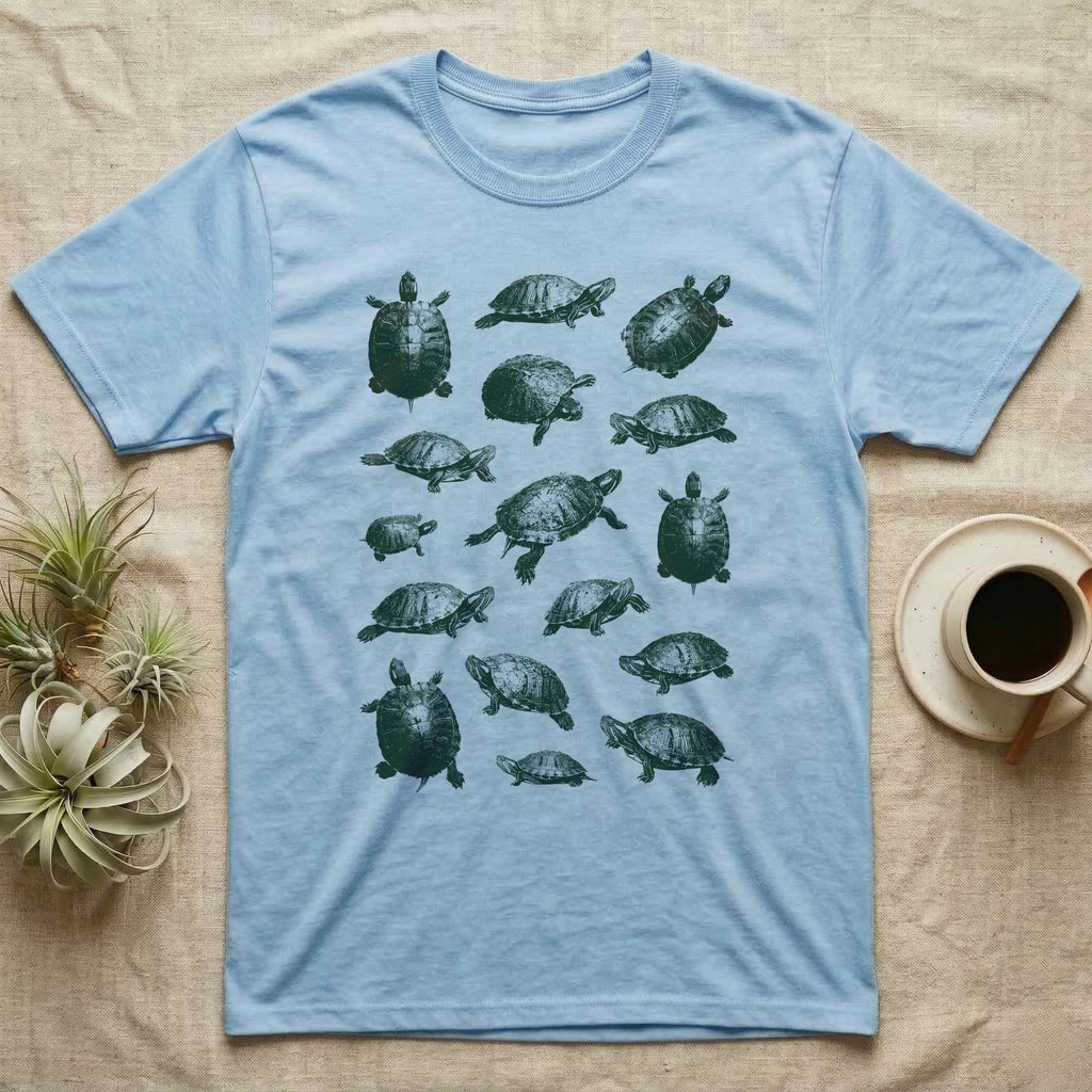 Red-Eared Slider Scatter T-Shirt in Light Blue — Seventeen red-eared sliders in one olive-green screen-print ink, scattered at varied scale, angle and size.