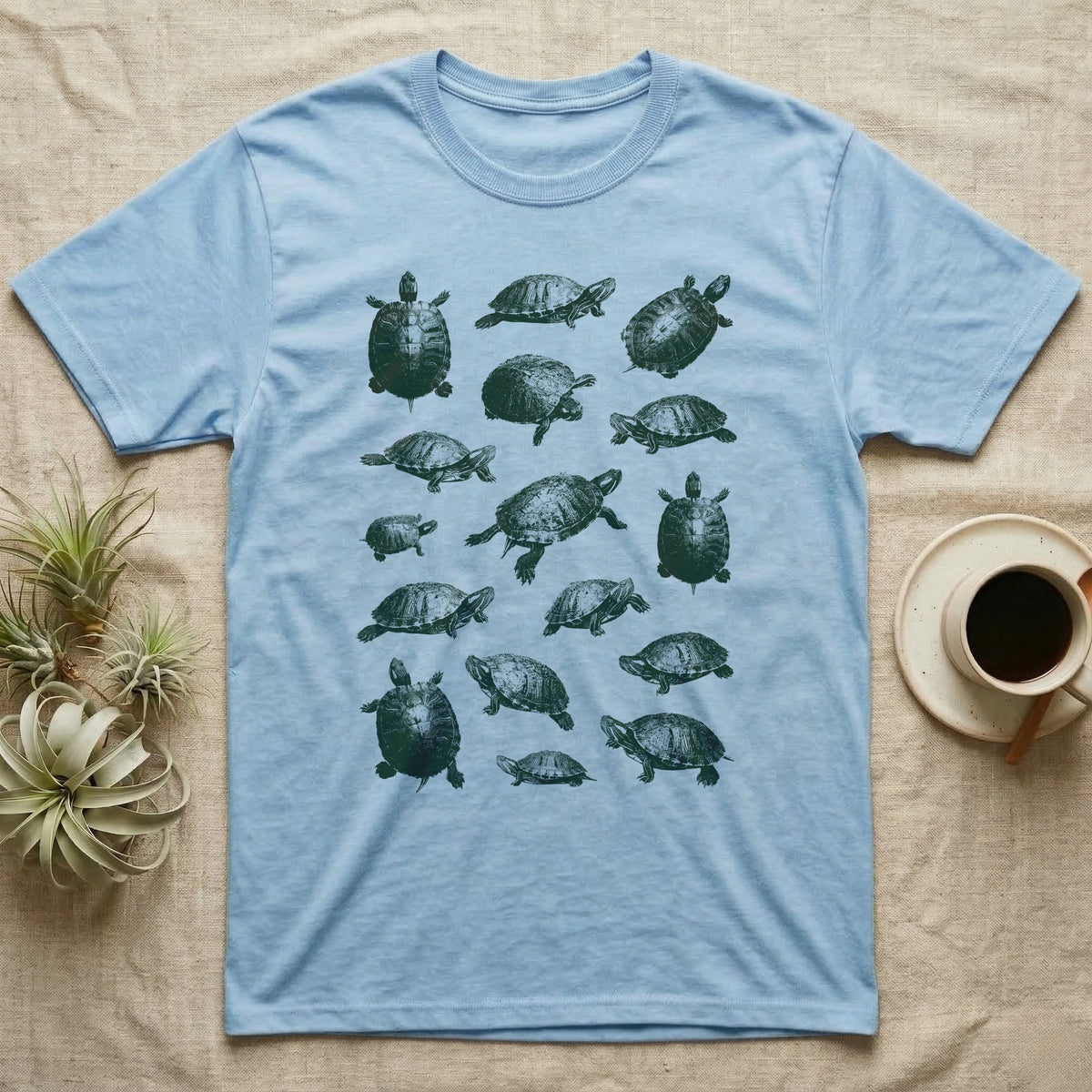 Red-Eared Slider Scatter T-Shirt in Light Blue — Seventeen red-eared sliders in one olive-green screen-print ink, scattered at varied scale, angle and size.