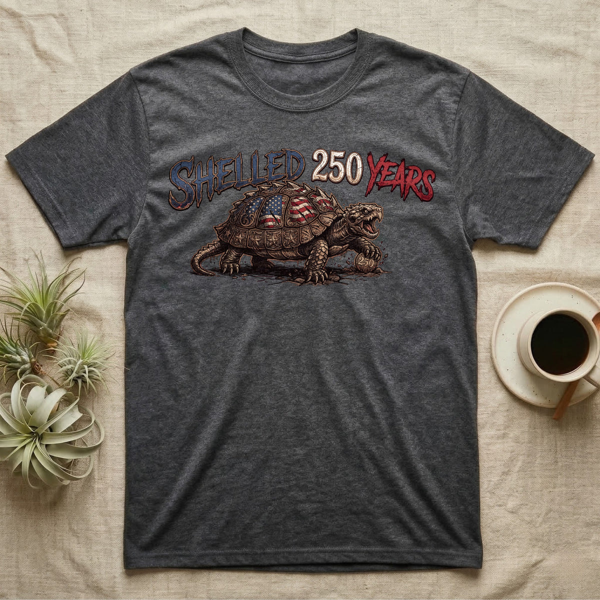 Snapping Turtle 250 T-Shirt in Dark Heather — Gritty woodcut alligator snapping turtle with a flag-etched shell on a 250 coin under text Shelled 250 Years.
