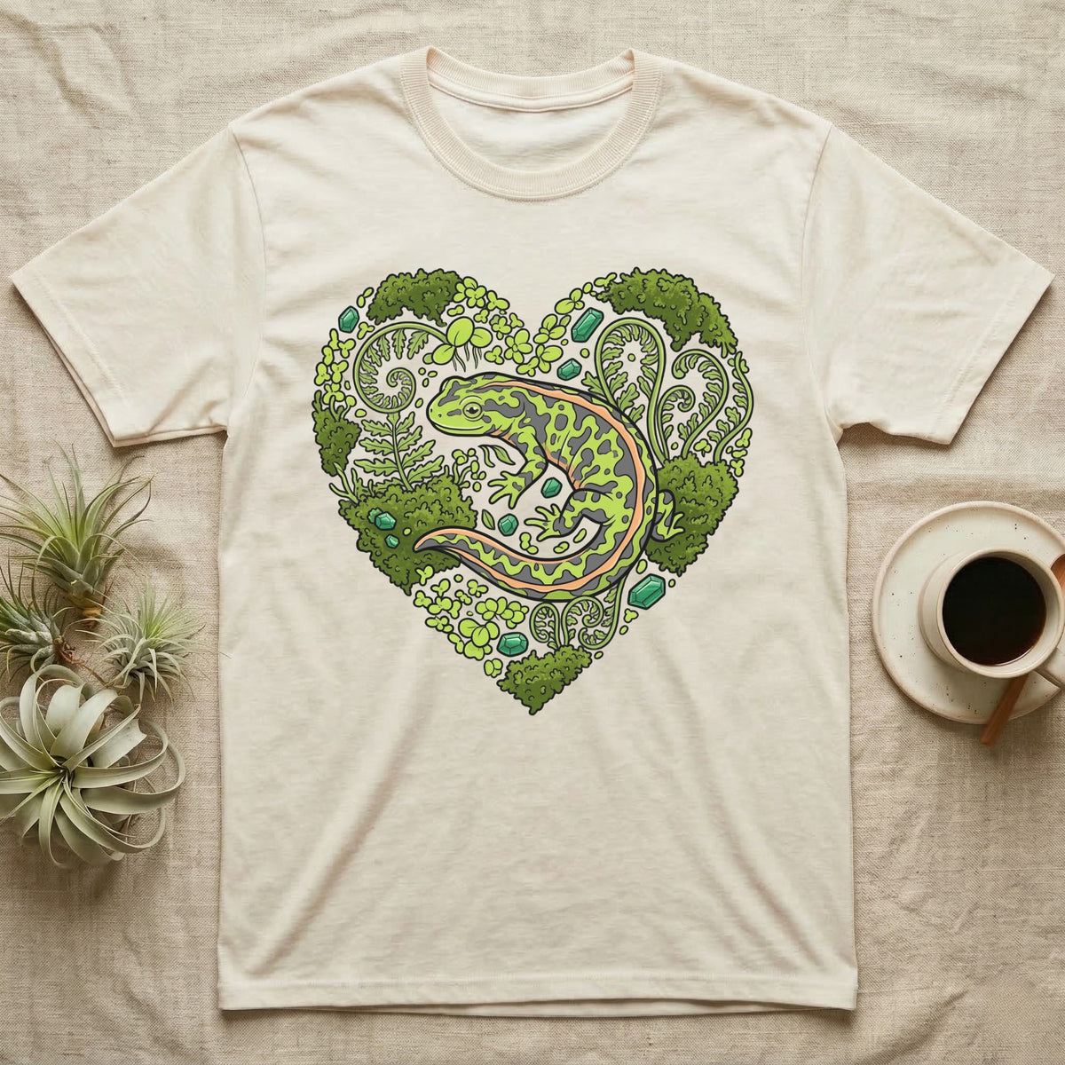 Cream t-shirt with a green salamander within a heart of ferns and leaves.