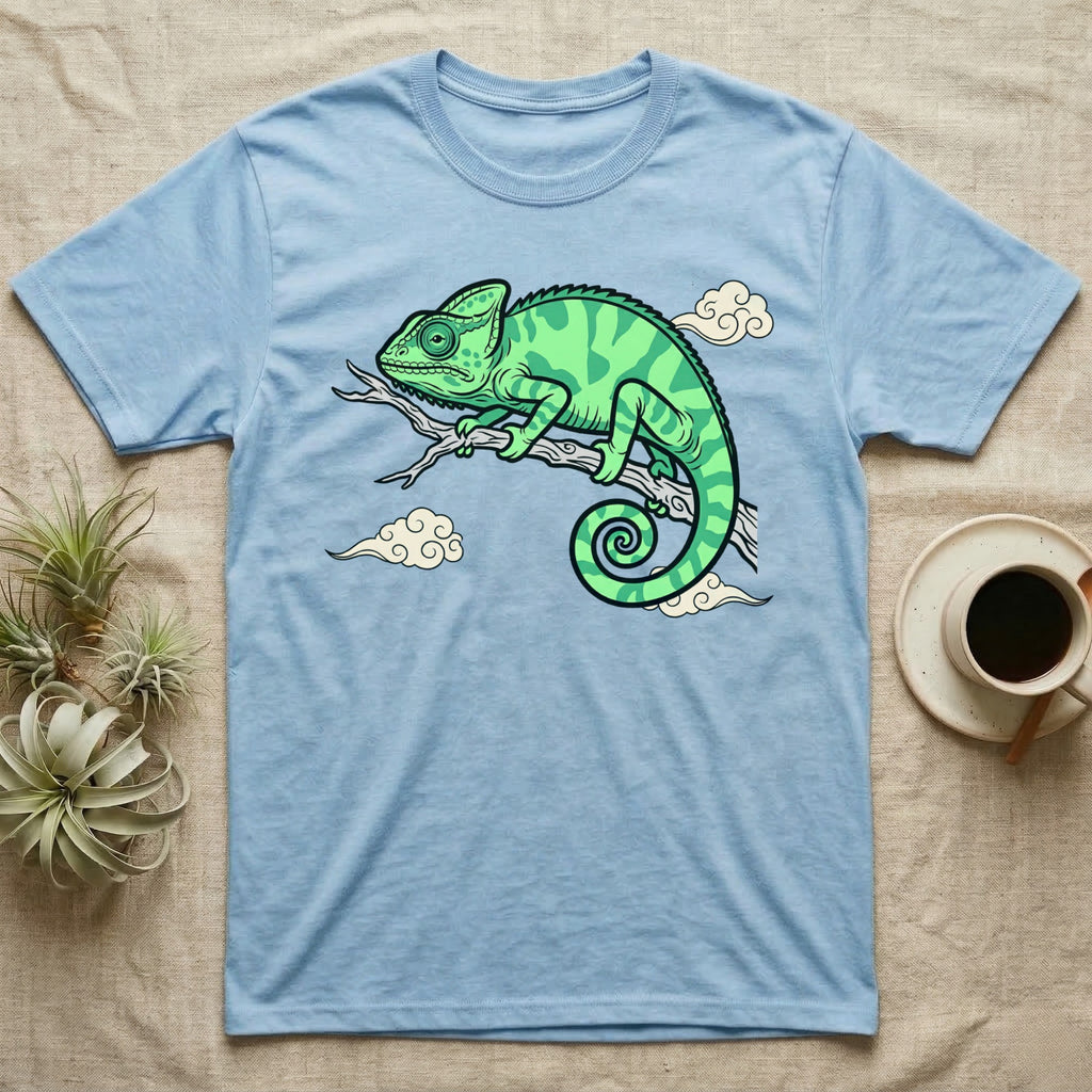 Light blue t-shirt with a green chameleon on a branch and clouds design.
