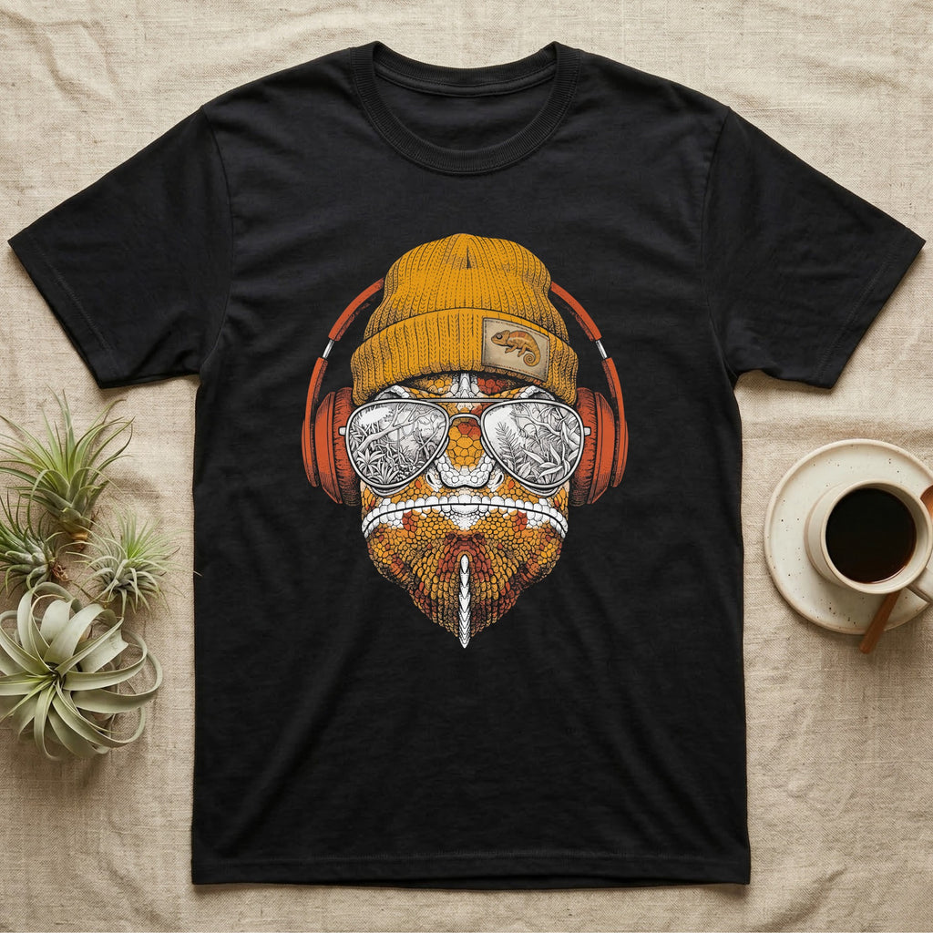 Chameleon Chill Vibes T-Shirt in Black — Engraved chameleon with patterned orange skin in a beanie and headphones, aviators reflecting a jungle canopy.